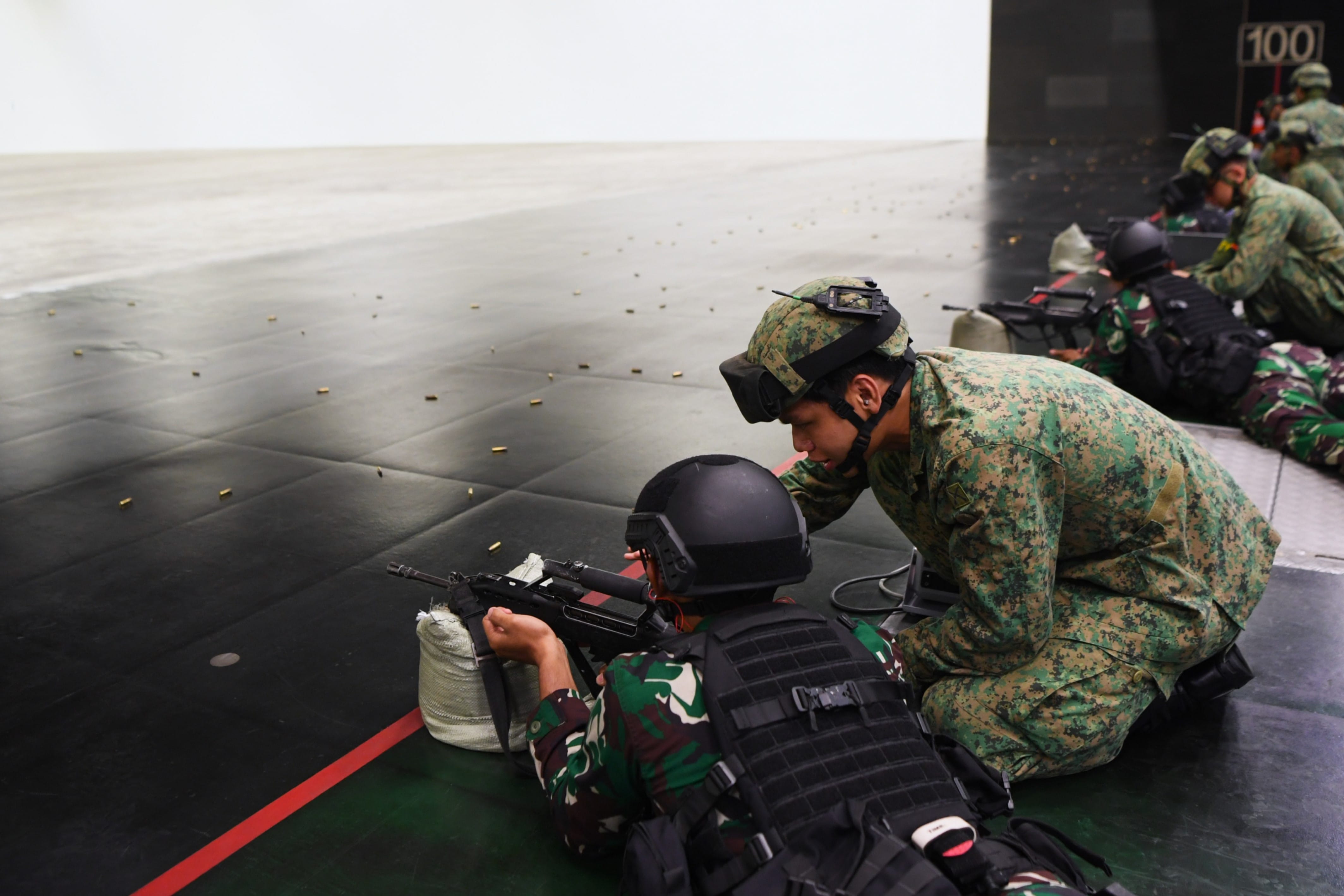 Soldiers from the Singapore Army introducing the Singapore Assault Rifle - 21st Century (SAR 21) to TNI-AD soldiers...